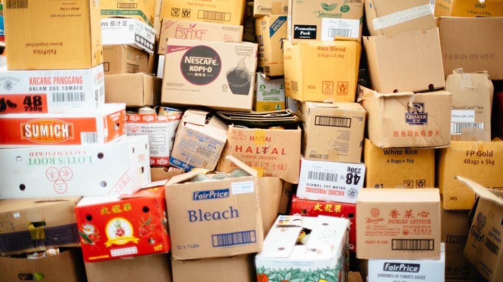 a large pile of packed cardboard boxes arranged in a haphazard manner
